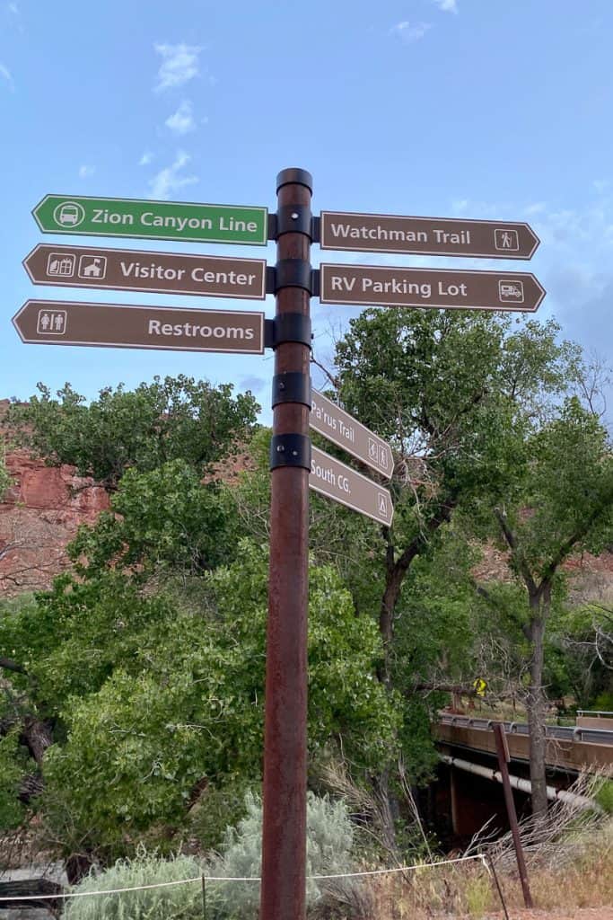 Signs for Watchman Trail, Visitor Center, other trails.