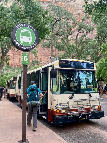 Zion shuttle bus stopped for hiker preparing to board.