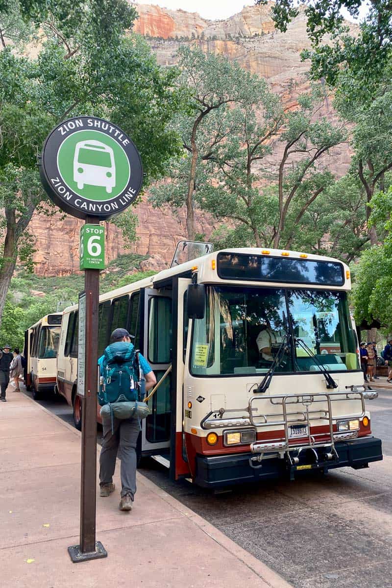 Zion shuttle bus stopped for hiker preparing to board.