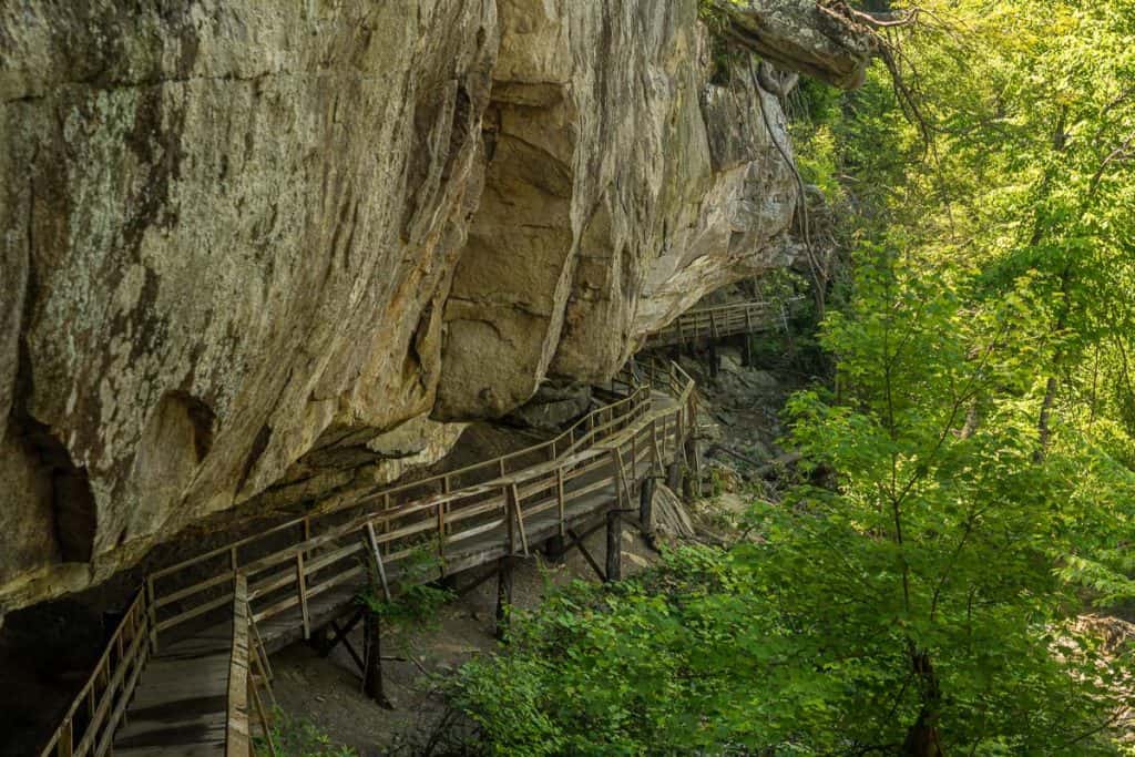 Wooden boardwalk under cliffs at Audra State Park.