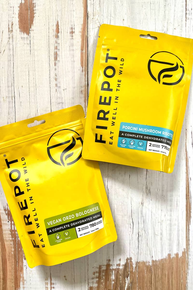 Firepot brand dehydrated meal packets for vegan bolognese and mushroom risotto.