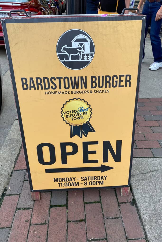 Outside placard displaying Bardstown Burger hours.