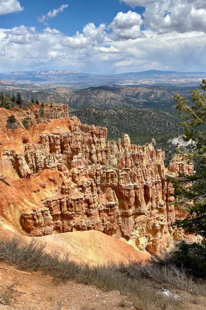 Reddish-brown rocky pillars carved from hillside viewed from Bryce Canyon scenic drive.