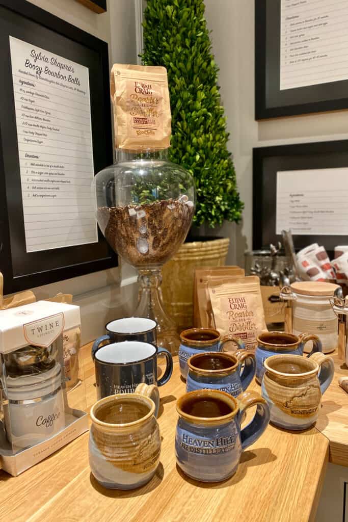Ceramic mugs and packages of bourbon coffee beans.