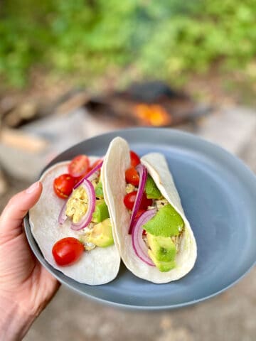 Campfire breakfast tacos on plate.