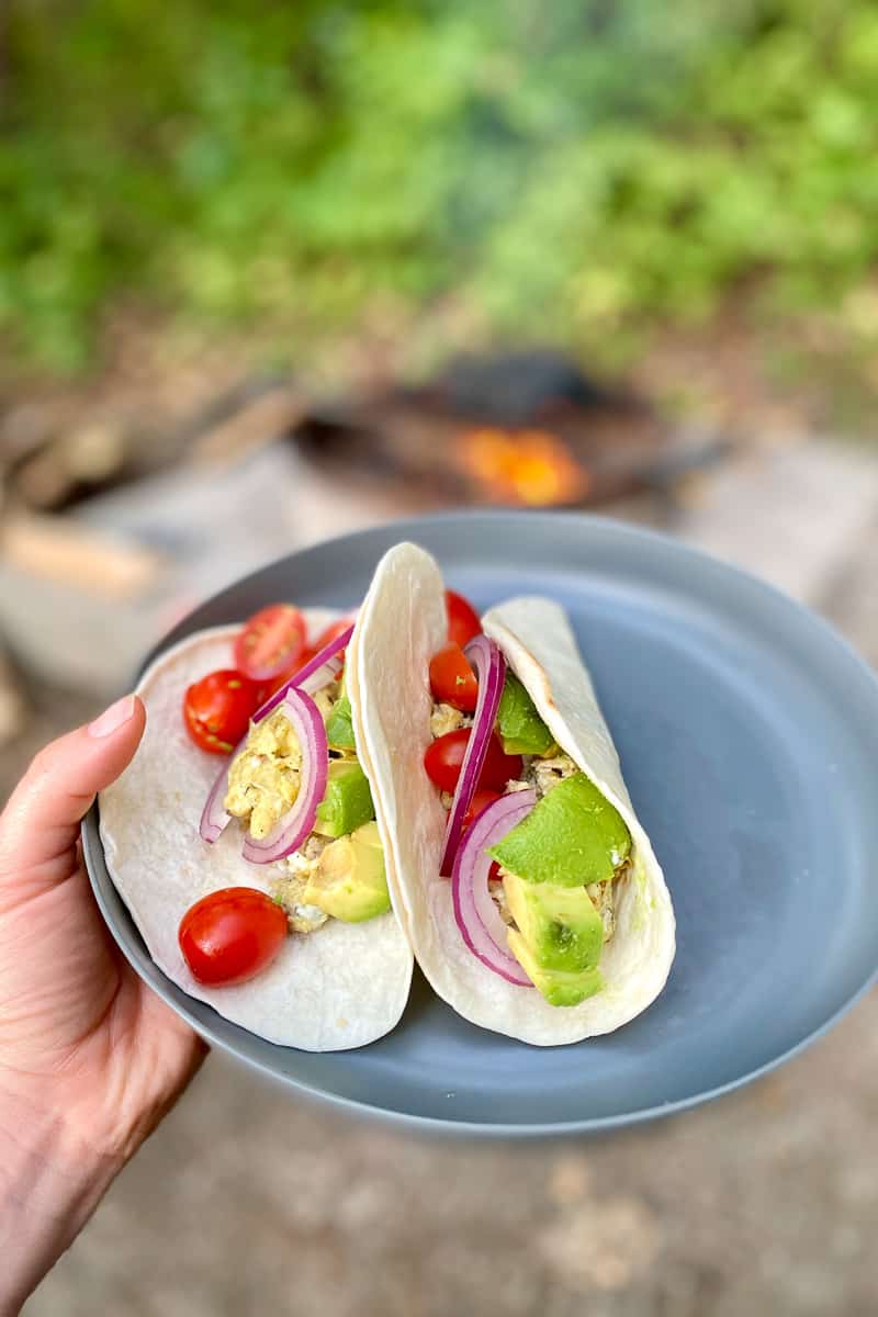 Campfire breakfast tacos on plate.