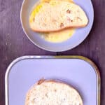 Slice of bread dipped in bowl of egg mixture.