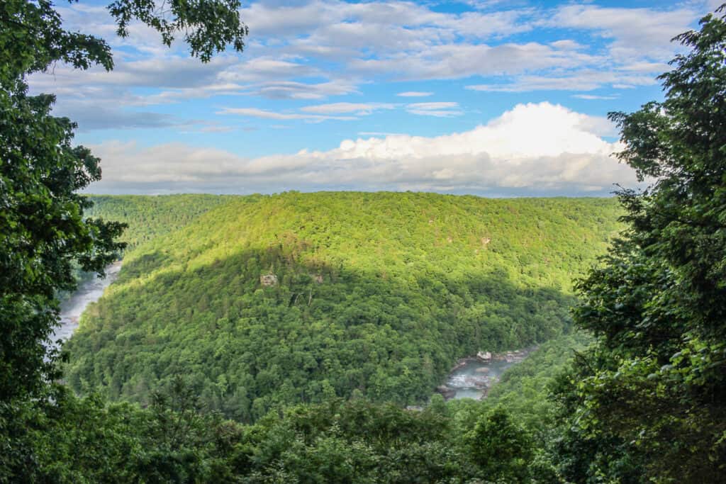 Overlook of horseshoe-shaped riverbend around wooded hill in Carnifex Ferry State Park.