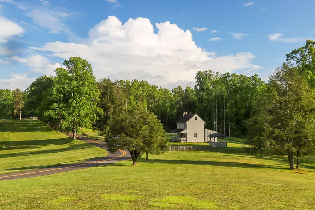 Road passing near two-story farm Patterson House.