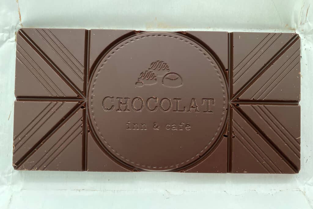 Bar of chocolate stamped with "Chocolat Inn & Cafe."