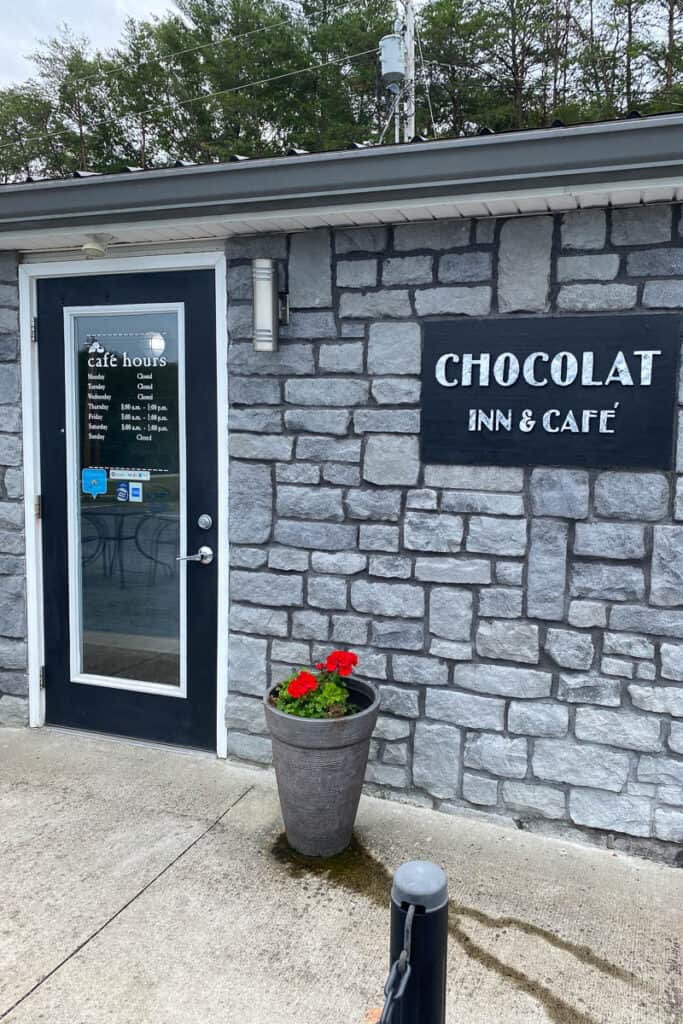 Rock exterior with sign for Chocolat Inn and Cafe.