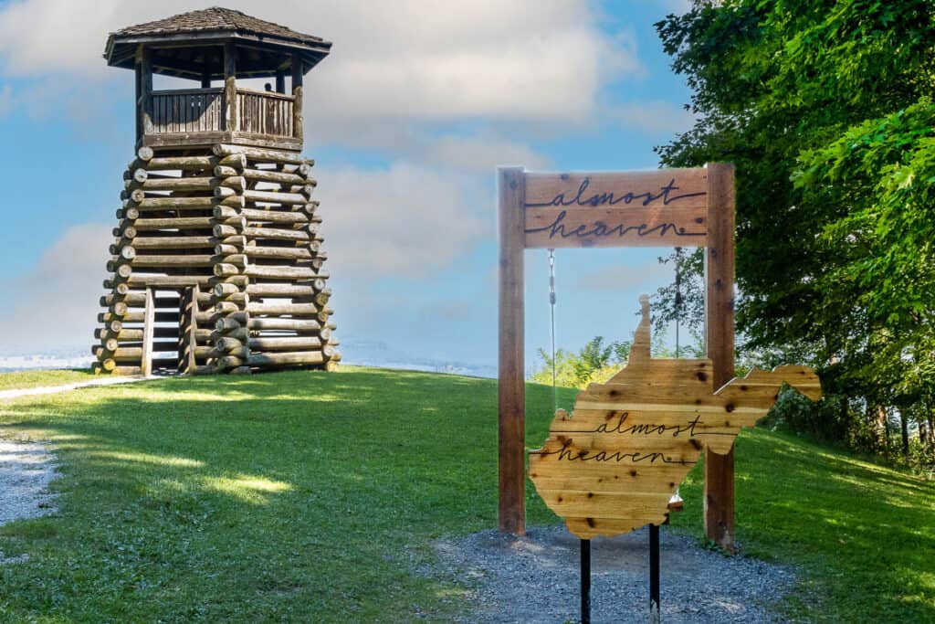 Lookout Tower with wooden sign shaped like West Virginia saying "almost heaven".