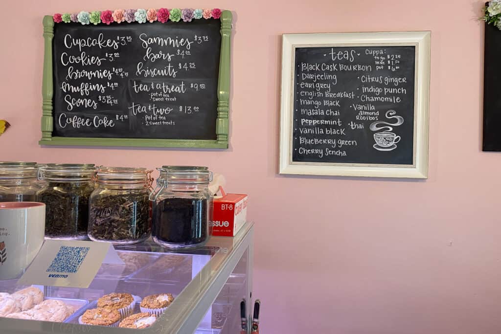 Pastry and tea menus on chalkboards at Olive's Apron.