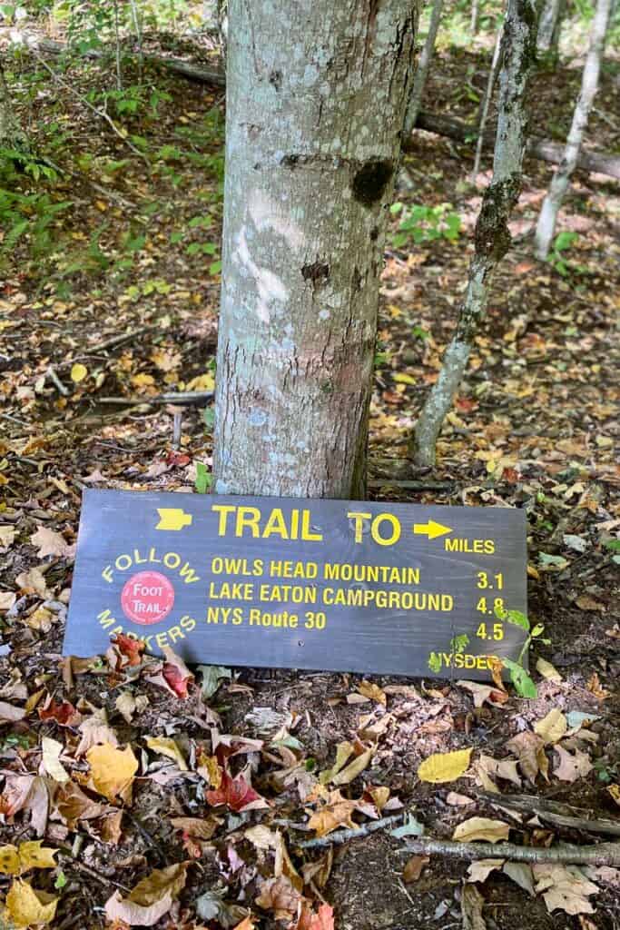 Sign with mileage to trails for Owls Head Mountain, Lake Eaton Campground, and NYS Route 30.