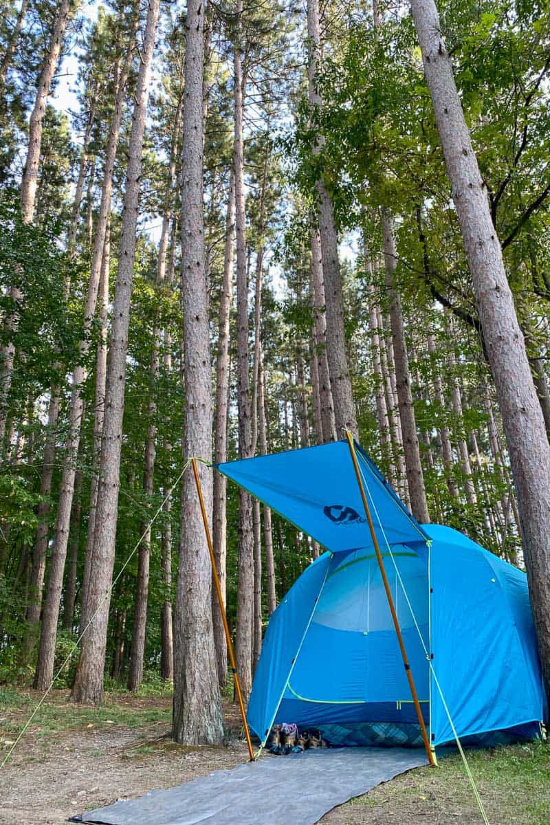 Blue dome tent with vestibule erected over entryway, one setup that lends to tent glamping.