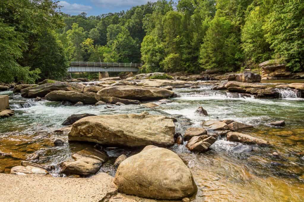 Middle Fork River and large boulders with bridge in background.