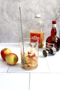 Apple slices and cider in glass.