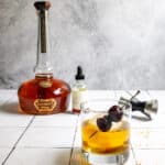 cinnamon old fashioned and bourbon bottle.