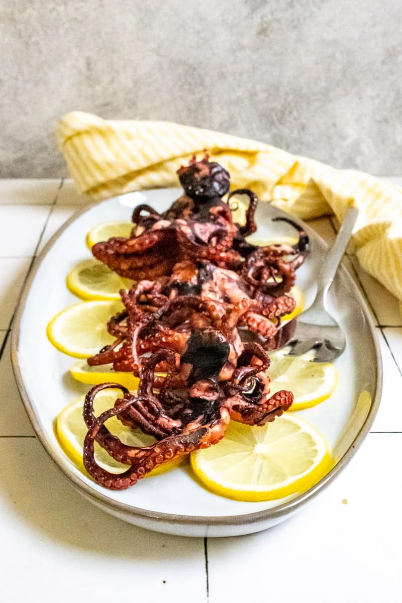 pan-seared octopus on a serving platter.