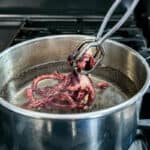 octopus being dipped in hot water.