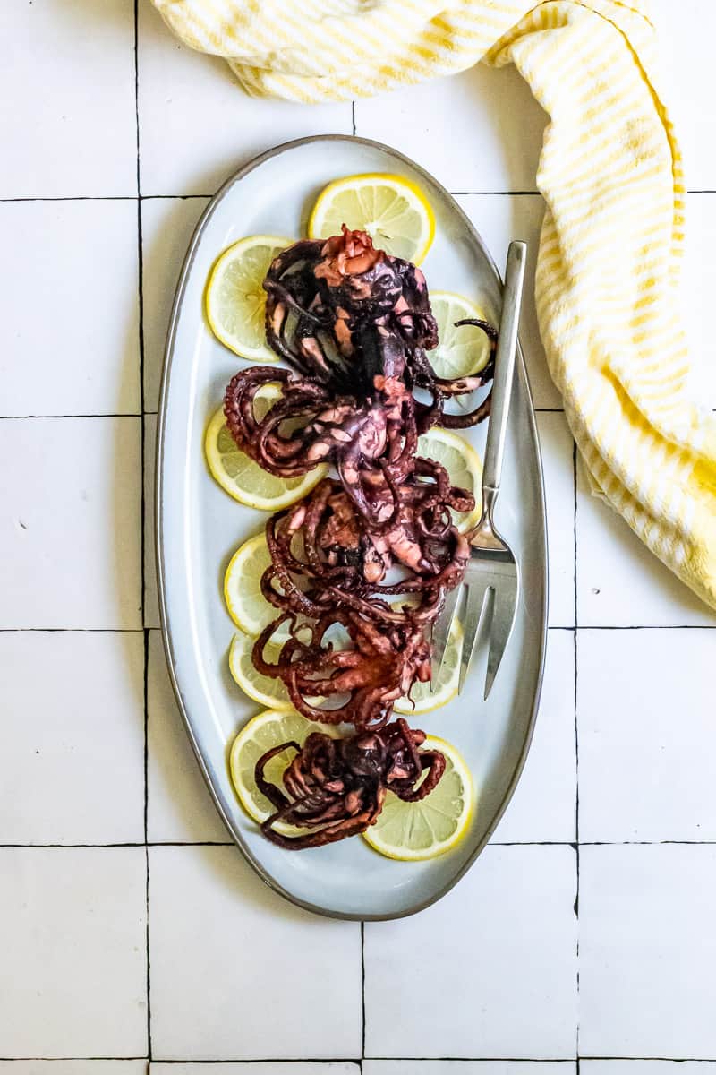 pan-seared octopus on a serving platter.