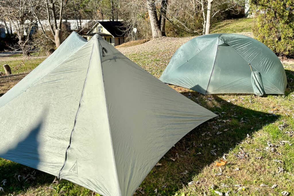Two ultralight tents pitched in yard.
