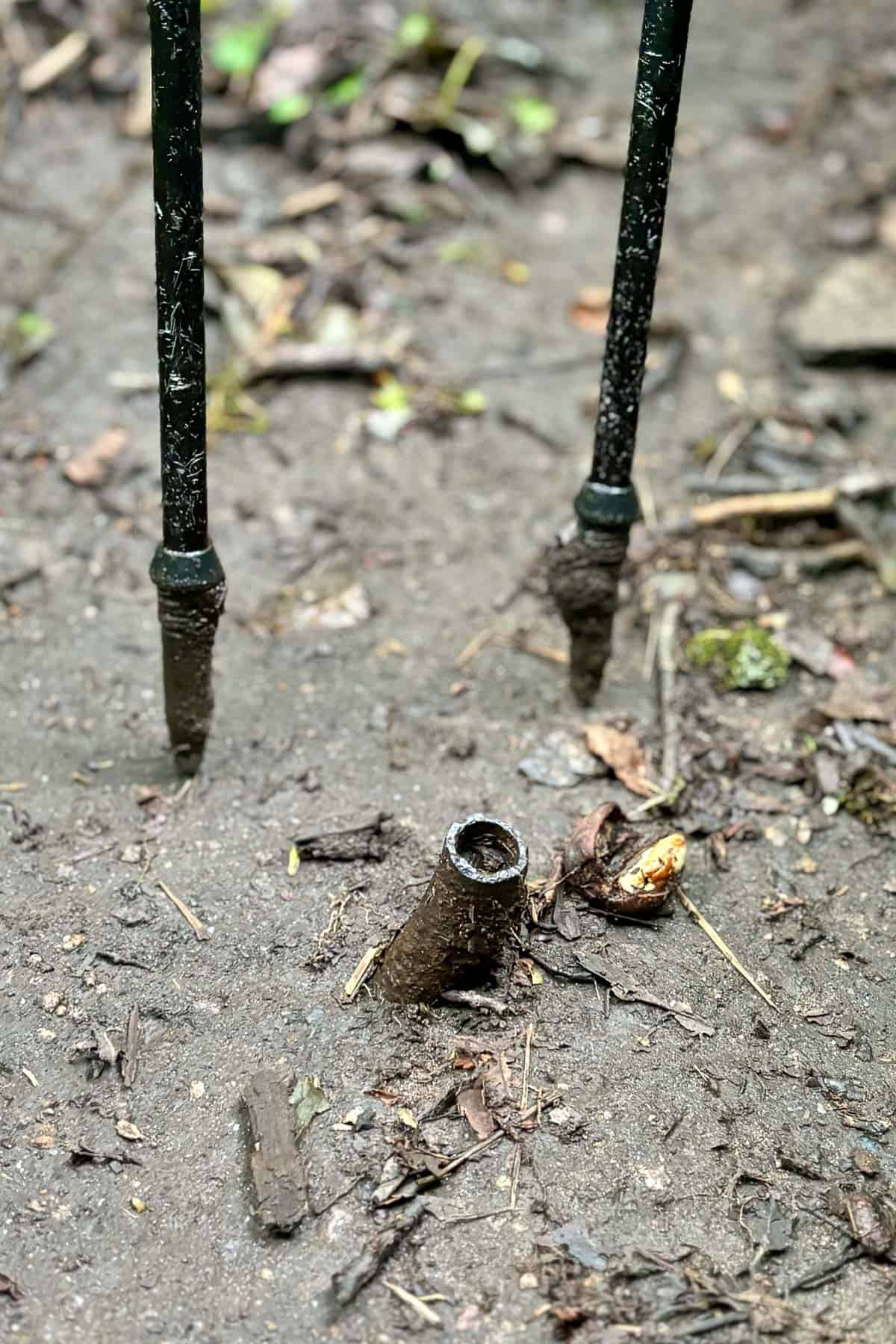 Metal pipe protruding from mud.