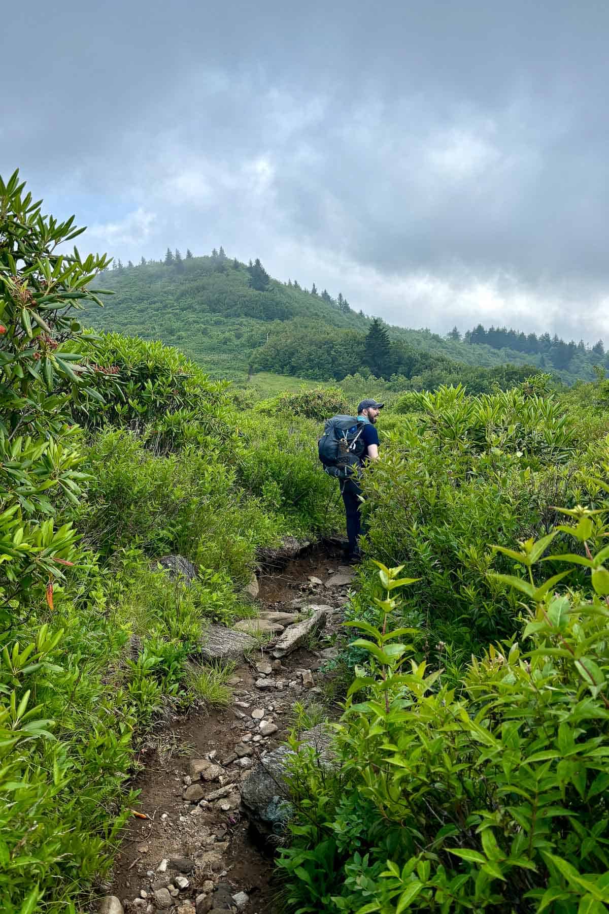 Backpacker on Art Loeb Trail under stormy skies.