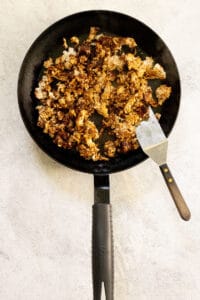 Taco meat cooking in skillet.