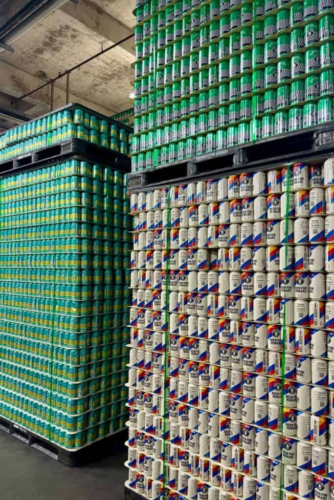 Palettes of beer cans stacked to ceiling.