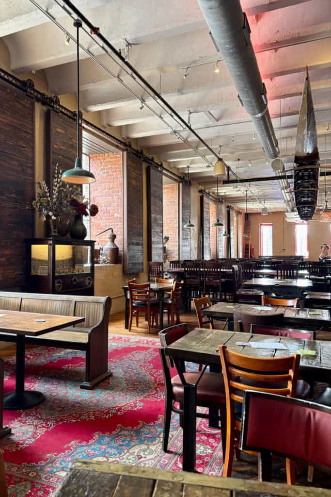 Wooden chairs and tables in elegant indoor dining area.