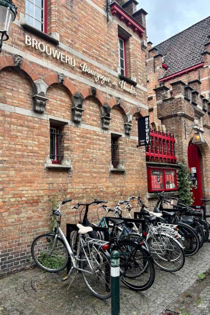 Brewery Bourgogne des Flandres with row of bikes parked on the cobblestones outside.