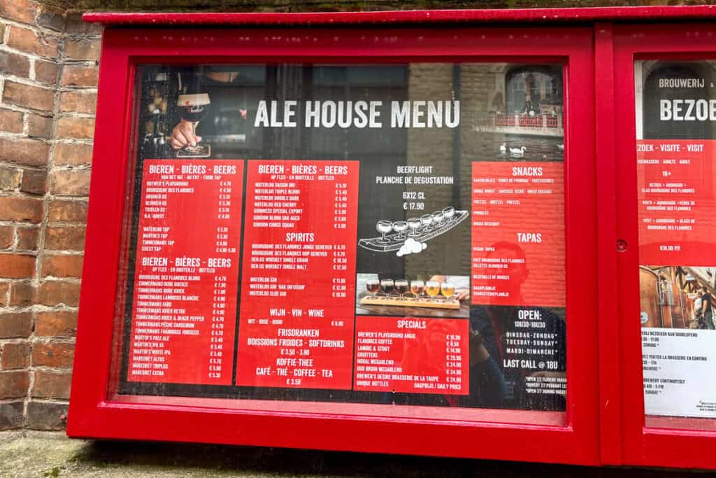 Ale house menu displayed in red frame outside brewery.