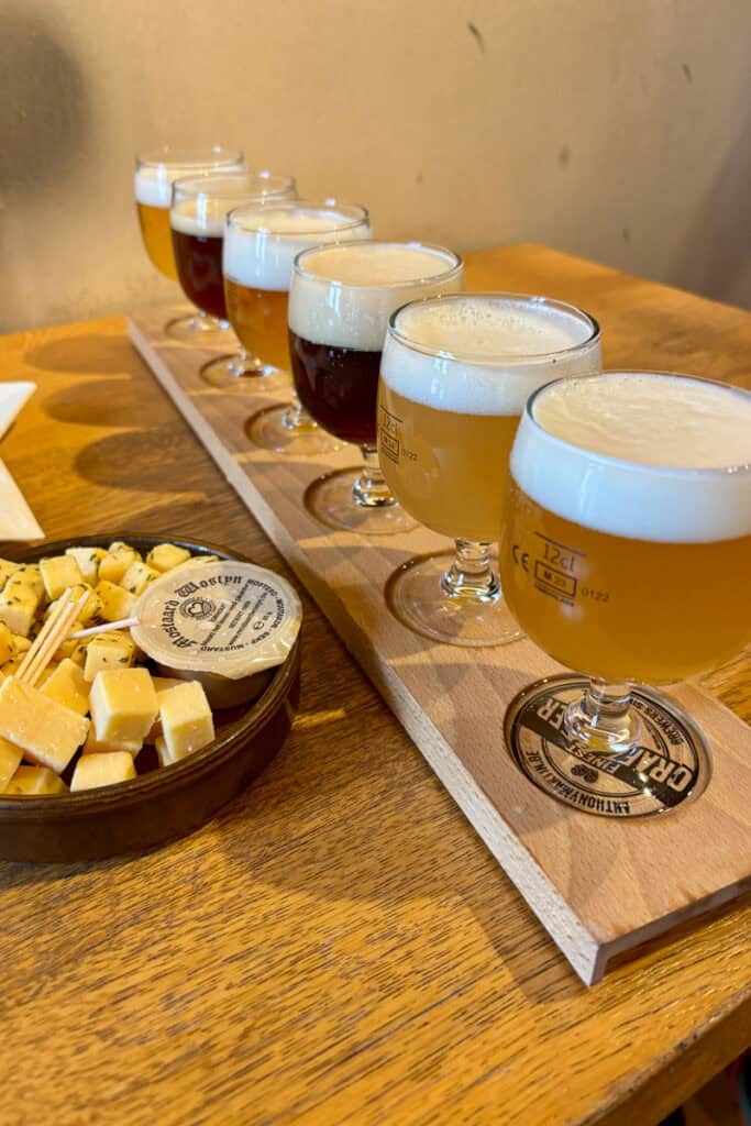Flight of beers and bowl of cheese cubes at Brewery Bourgogne des Flandres.