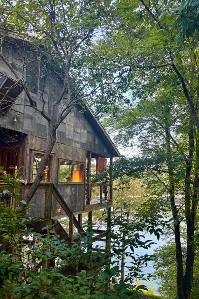 View of covered porch at Foglight Foodhouse, including staircase connecting the building to the riverfront.