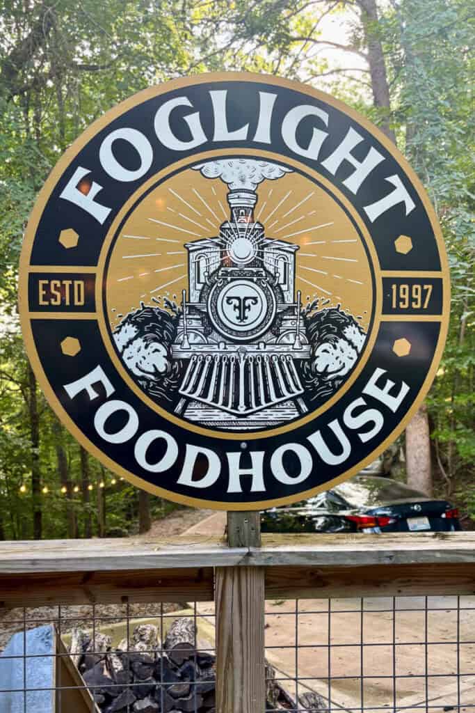 Sign for Foglight Foodhouse featuring illustration of locomotive.