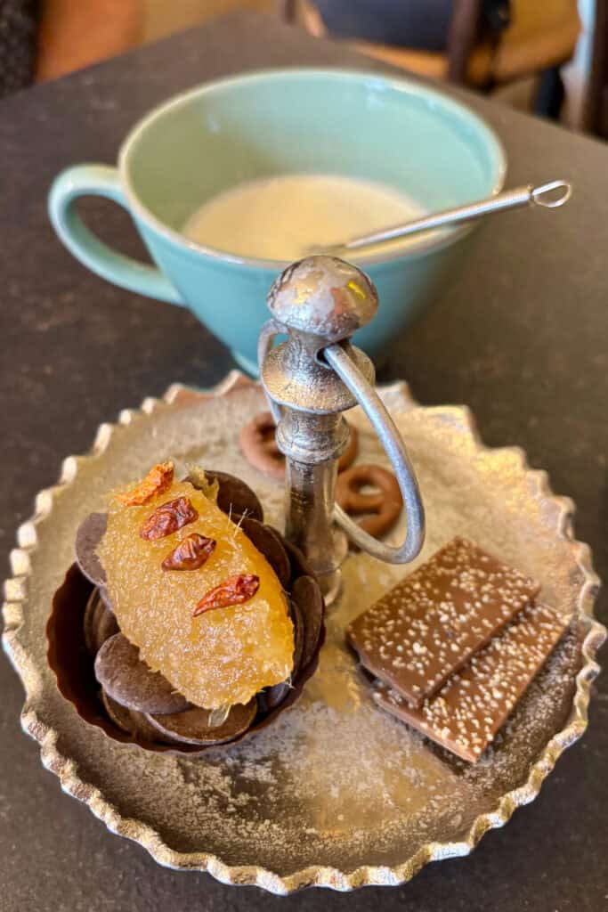 Tray of diabolo hot chocolate ingredients, including chocolate wafers, ginger, and chili peppers,