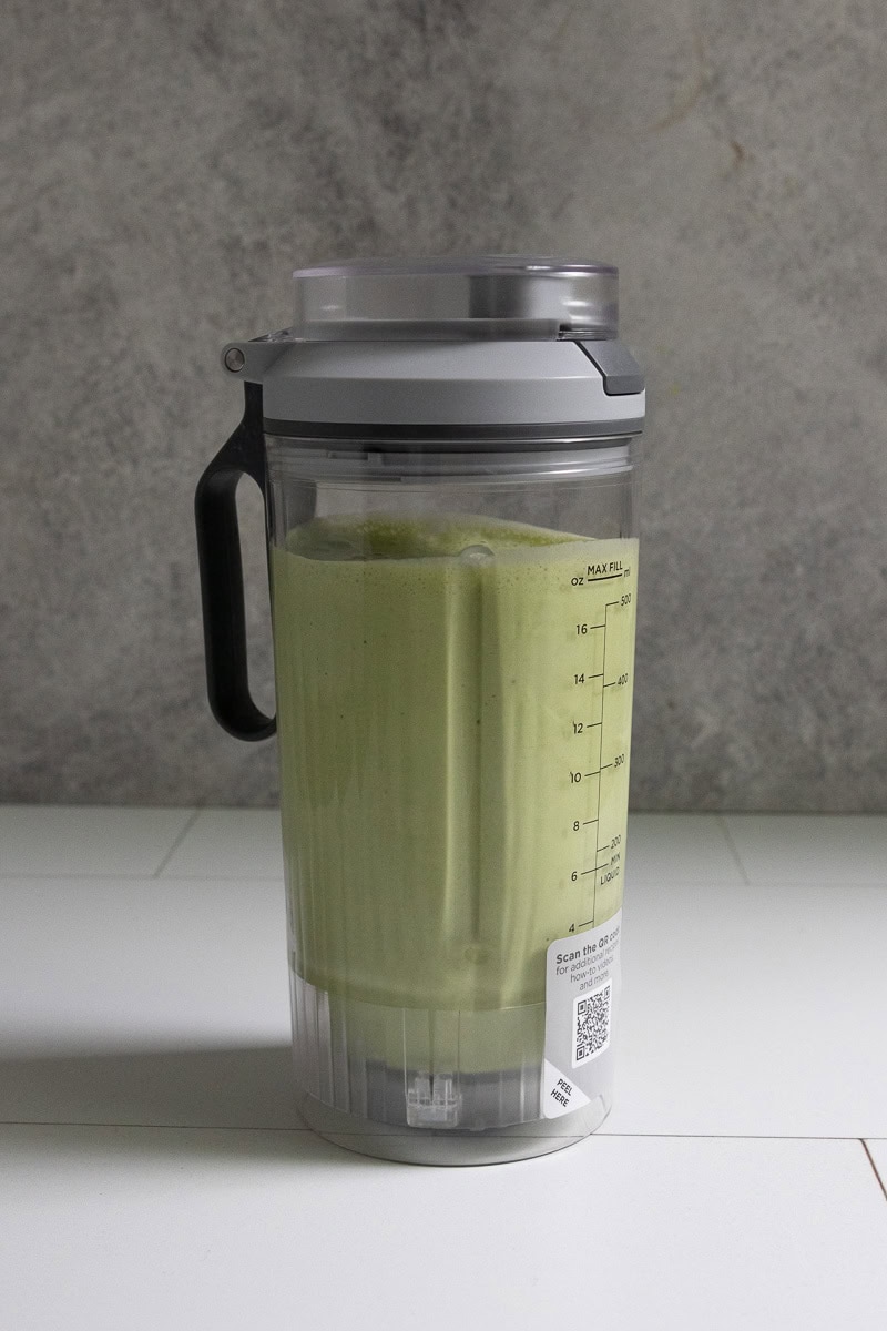 Kale protein smoothie in blender cup.