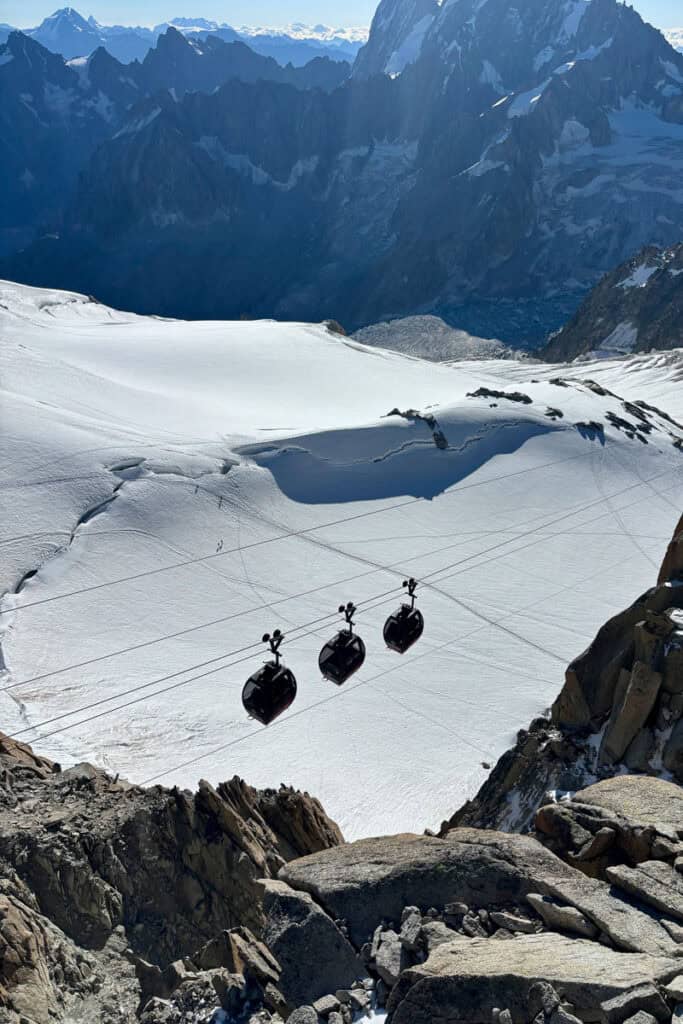 Three small cable cars ascending Aiguille du Midi.