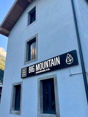 Tall plaster building with sign for Big Mountain Brewing Co.