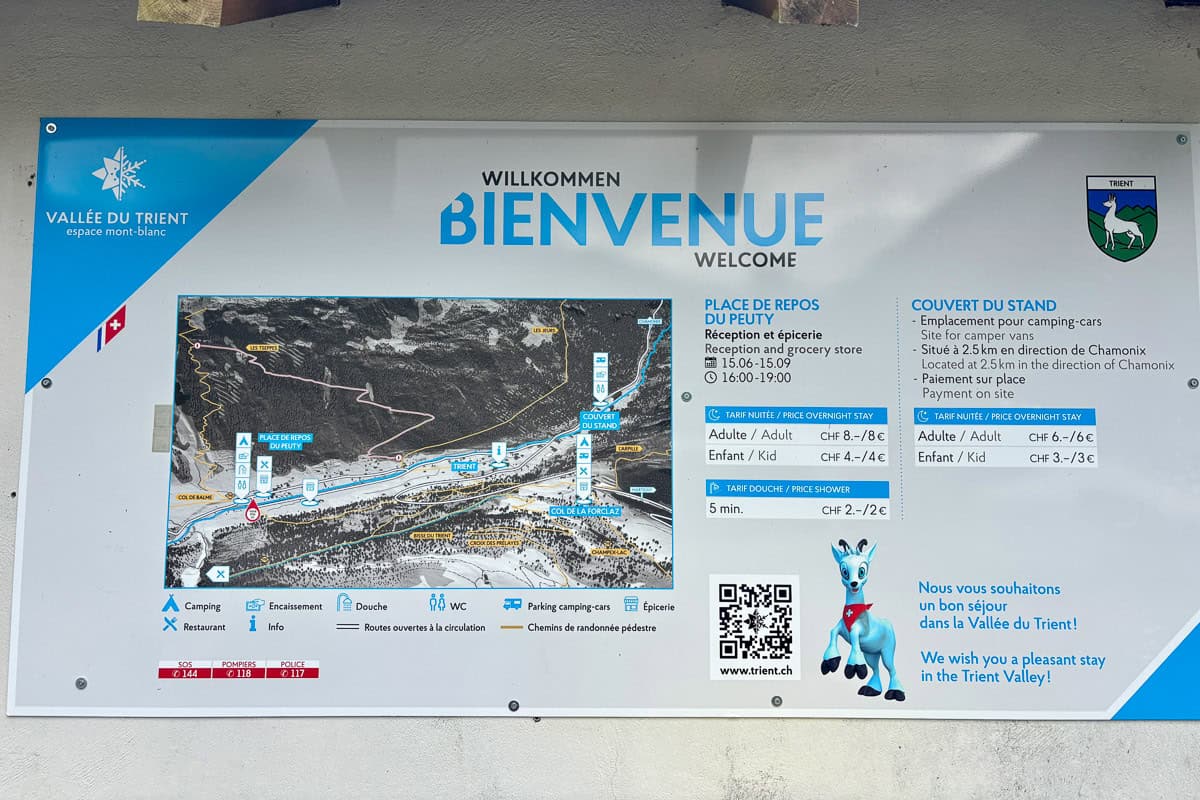 Welcome sign with map of camping area and prices listed.
