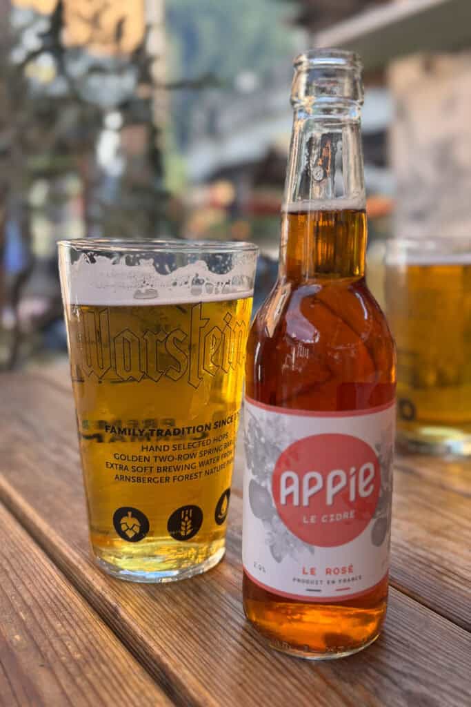 Glass of beer and bottle of cider.