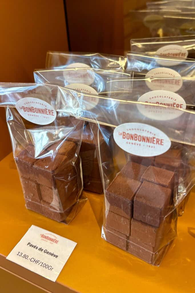 Paves, small chocolate cubes dusted with chocolate powder and packaged for sale.