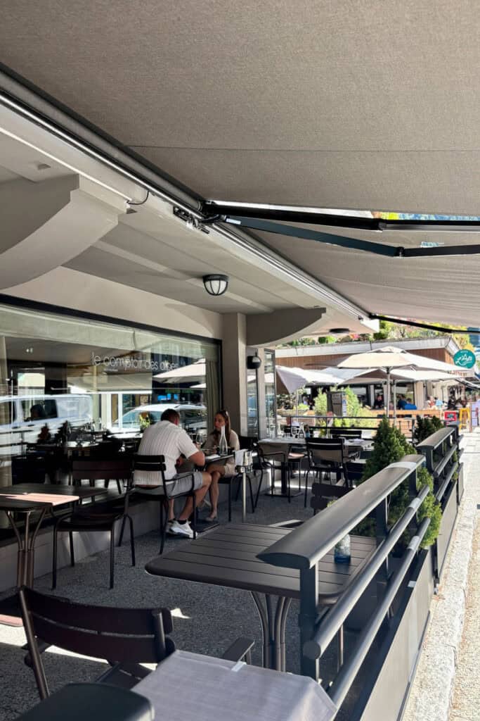 Outdoor shaded dining area at Le Comptoir des Alpes.