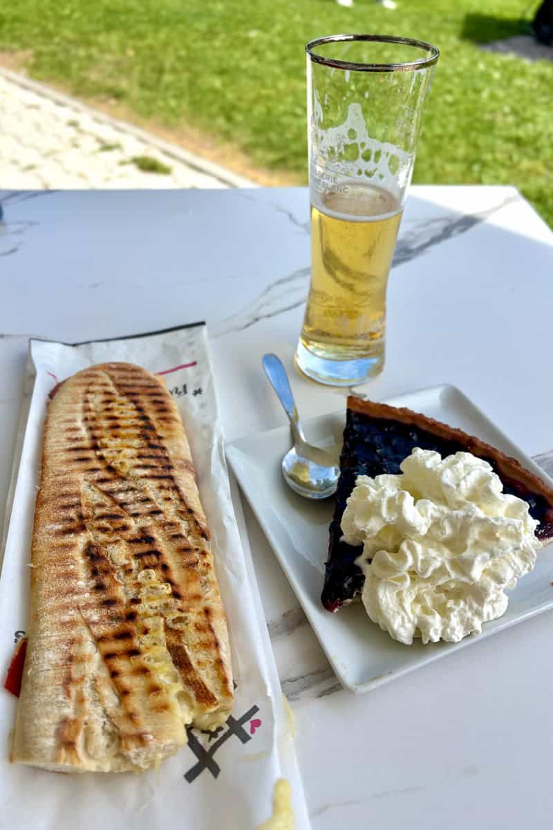 Panini, pie with whipped cream, and glass of beer, options among the best food and drink on the Tour du Mont Blanc.