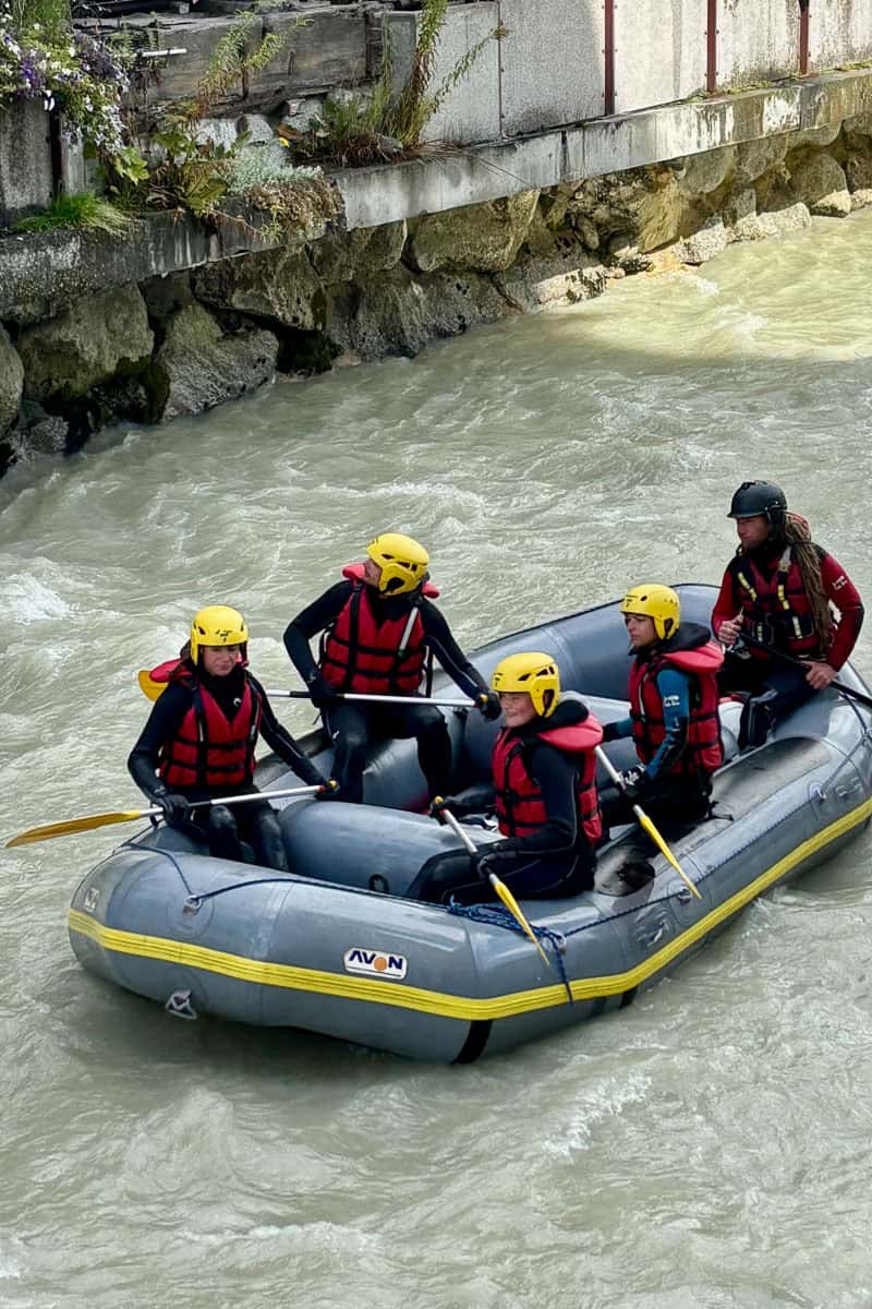 Group of five people in raft floating on river in Chamonix.