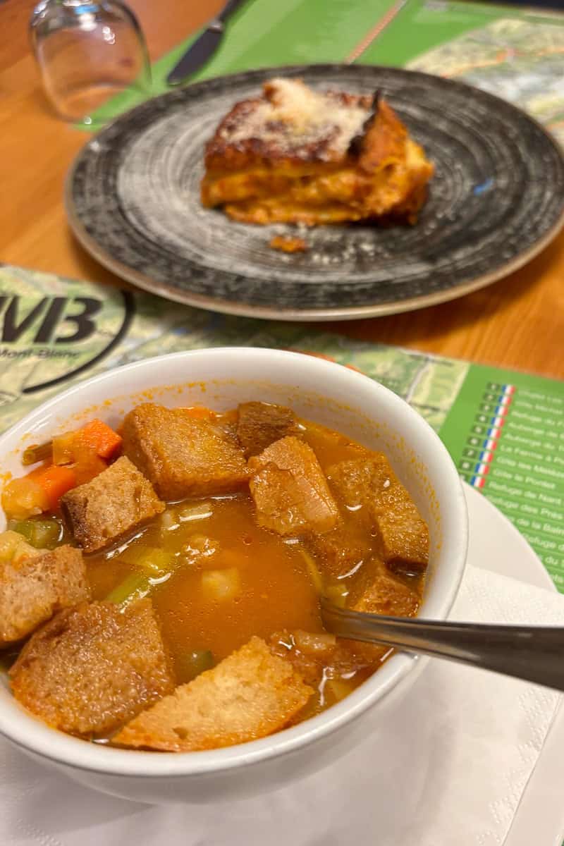 Bowl of vegetable soup with large croutons.