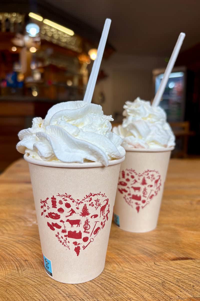 Two hot chocolates piled high with whipped cream.