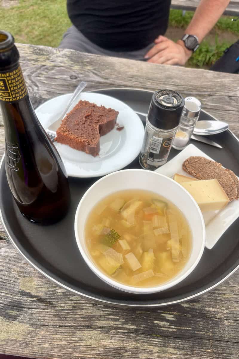 Bowl of soup, slice of chocolate cake, and bottle of beer, choices among the best food and drink on the Tour du Mont Blanc.