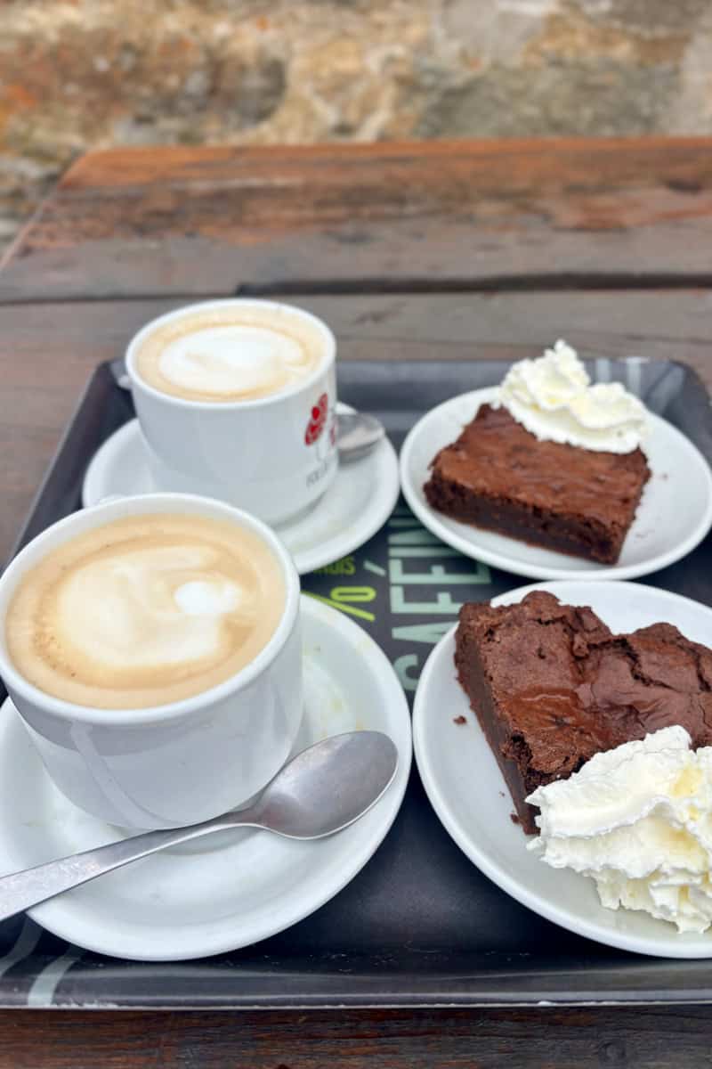 Two cappuccinos and two brownies with whipped cream, choices we found among the best food and drink on the Tour du Mont Blanc.